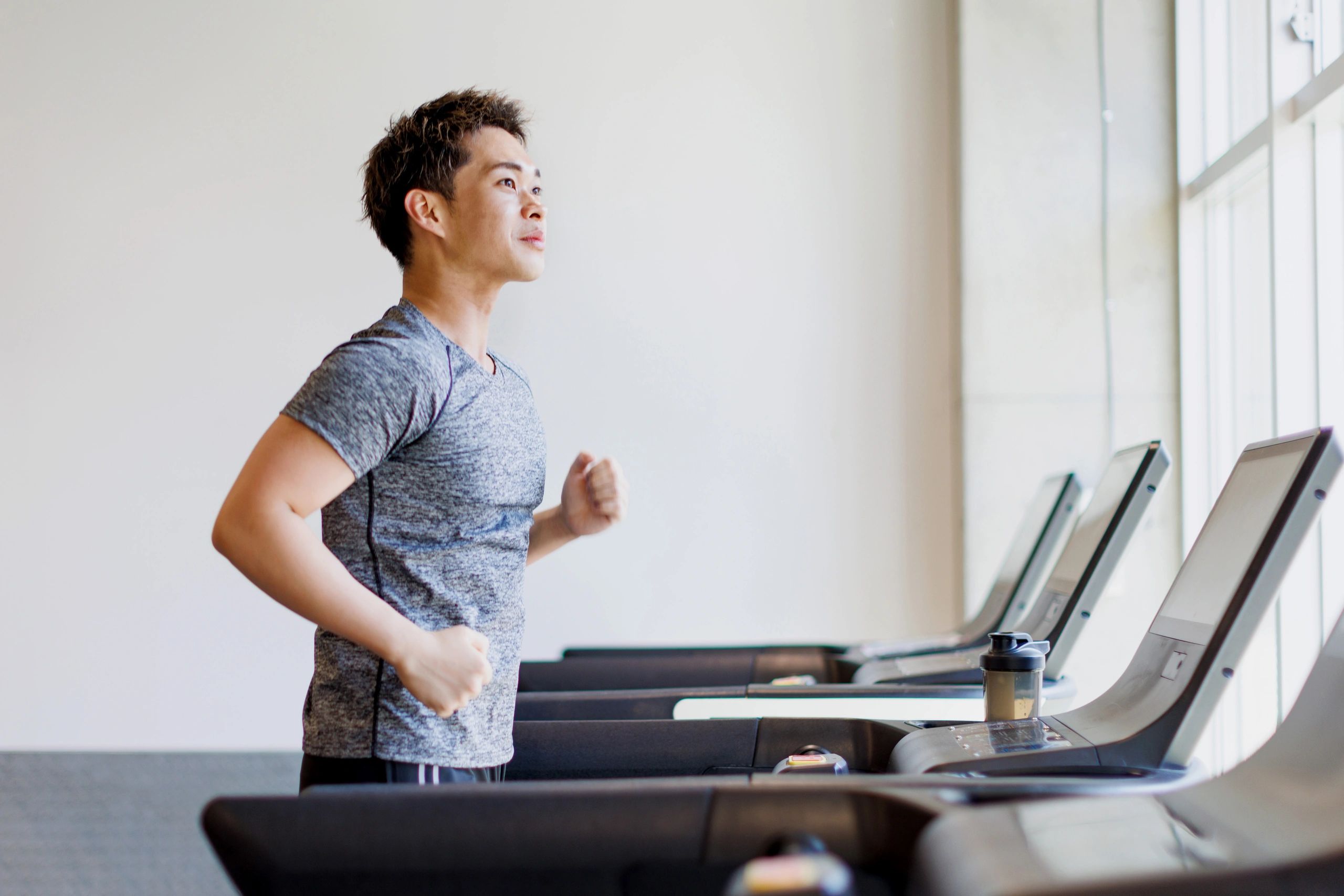 Young man running on treadmill